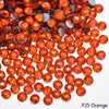 Orange rhinestones scattered on a white background for DIY crafts and clothing decoration