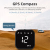 A black GPS compass device is shown on a wooden surface with a car in the background, demonstrating its navigation features.
