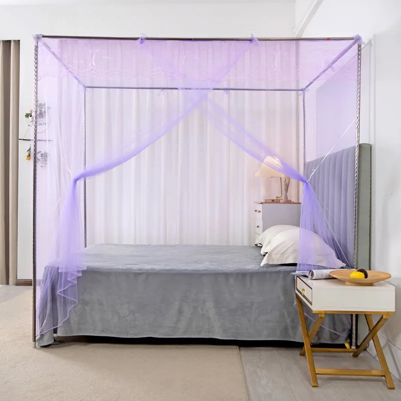 A princess-style lace canopy mosquito net draped over a bed in a room.