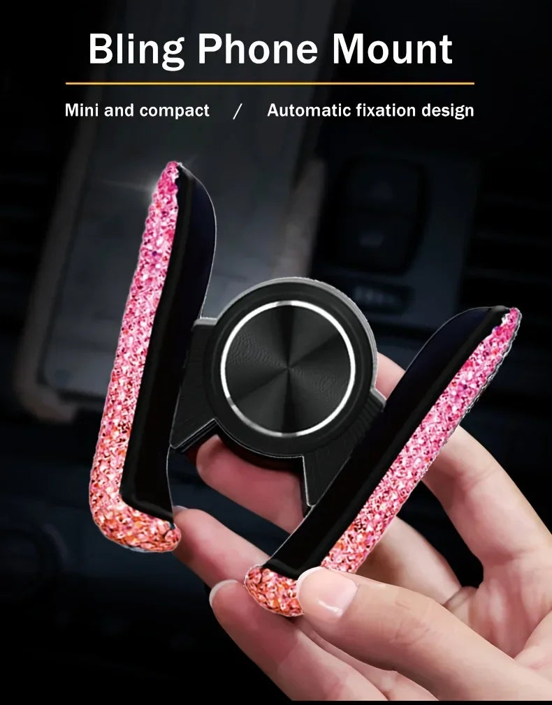 A hand holds a pink glitter phone mount designed for automatic fixation on a phone.
