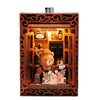 A wooden DIY book nook featuring a bear figure and illuminated display inside.