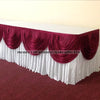 Elegant ice silk table skirt with matching top swag in deep maroon and white fabric.