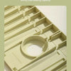 A close-up view of a silicone faucet draining mat with raised edges, showing its structure and texture.