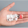 A hand holds a small deck of mini playing cards with various suits and designs.