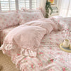 Pink floral ruffle cotton duvet cover set displayed on a bed with white plantation shutters.