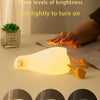 A rechargeable silicone duck touch night light demonstrating three dimming levels: lighting, ambient light, and sleep light.