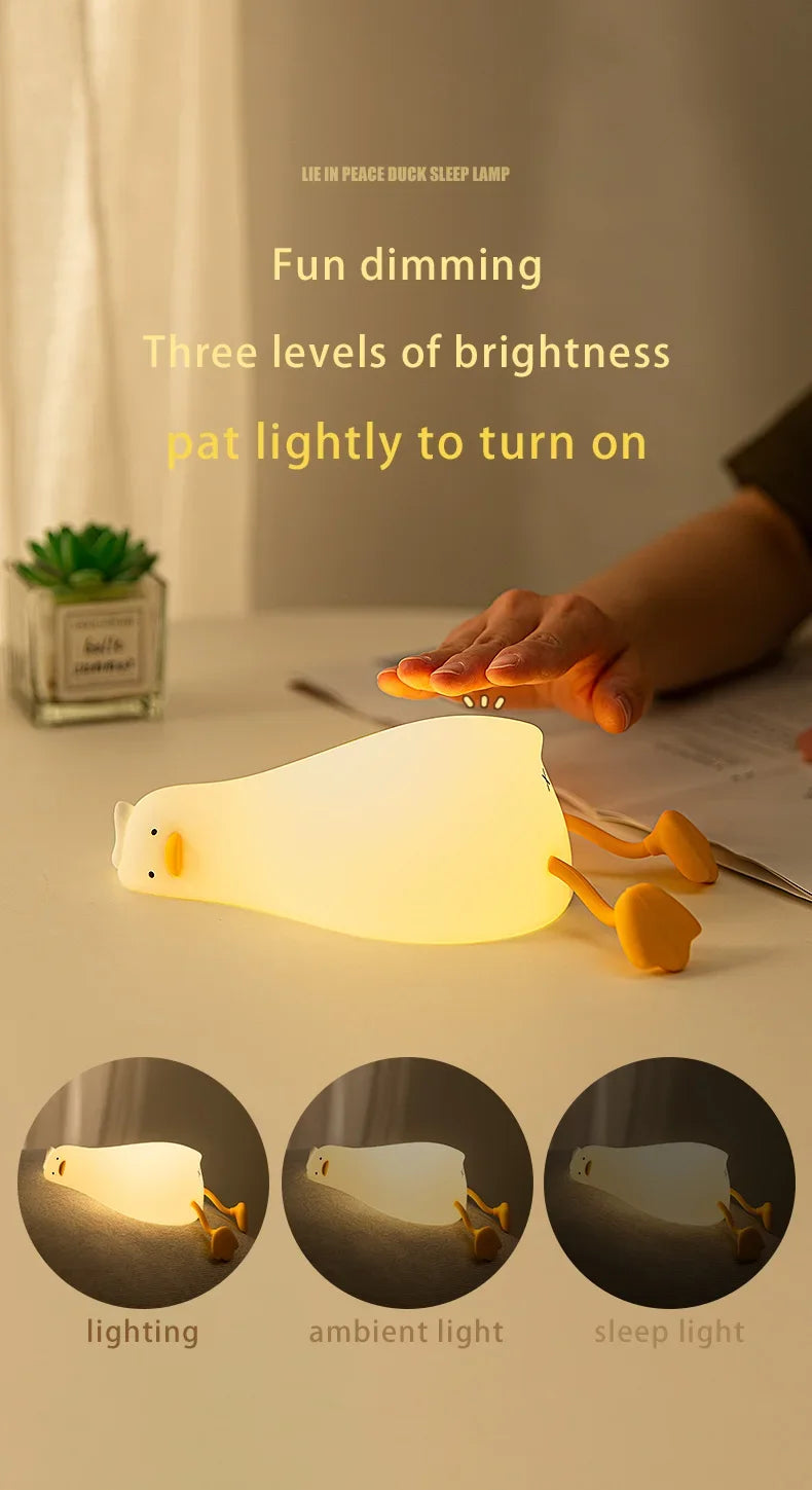 A rechargeable silicone duck touch night light demonstrating three dimming levels: lighting, ambient light, and sleep light.