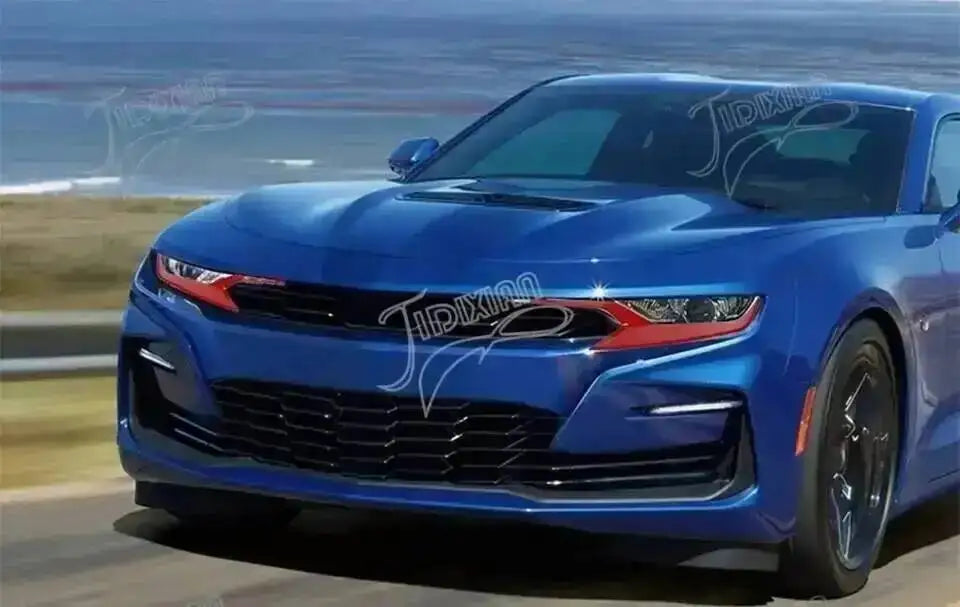 A blue Chevrolet Camaro sports car driving on a road with red trim accents.