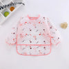 A pink waterproof long sleeve smock and feeding bib featuring a pattern of small pink flamingos on a white background.