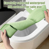 A hand is placing a light green waterproof EVA toilet seat cover onto a white toilet bowl.