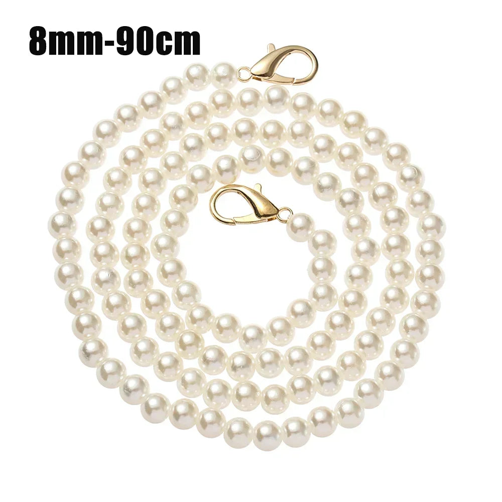 A strand of small, round white pearls on a gold-toned chain with a clasp.