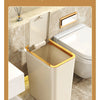 A beige pop-up slim trash can is shown with its lid opened to a 90-degree angle in a bathroom setting.