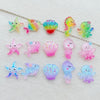 A collection of colorful, translucent resin charms shaped like starfish and sea creatures for crafting.