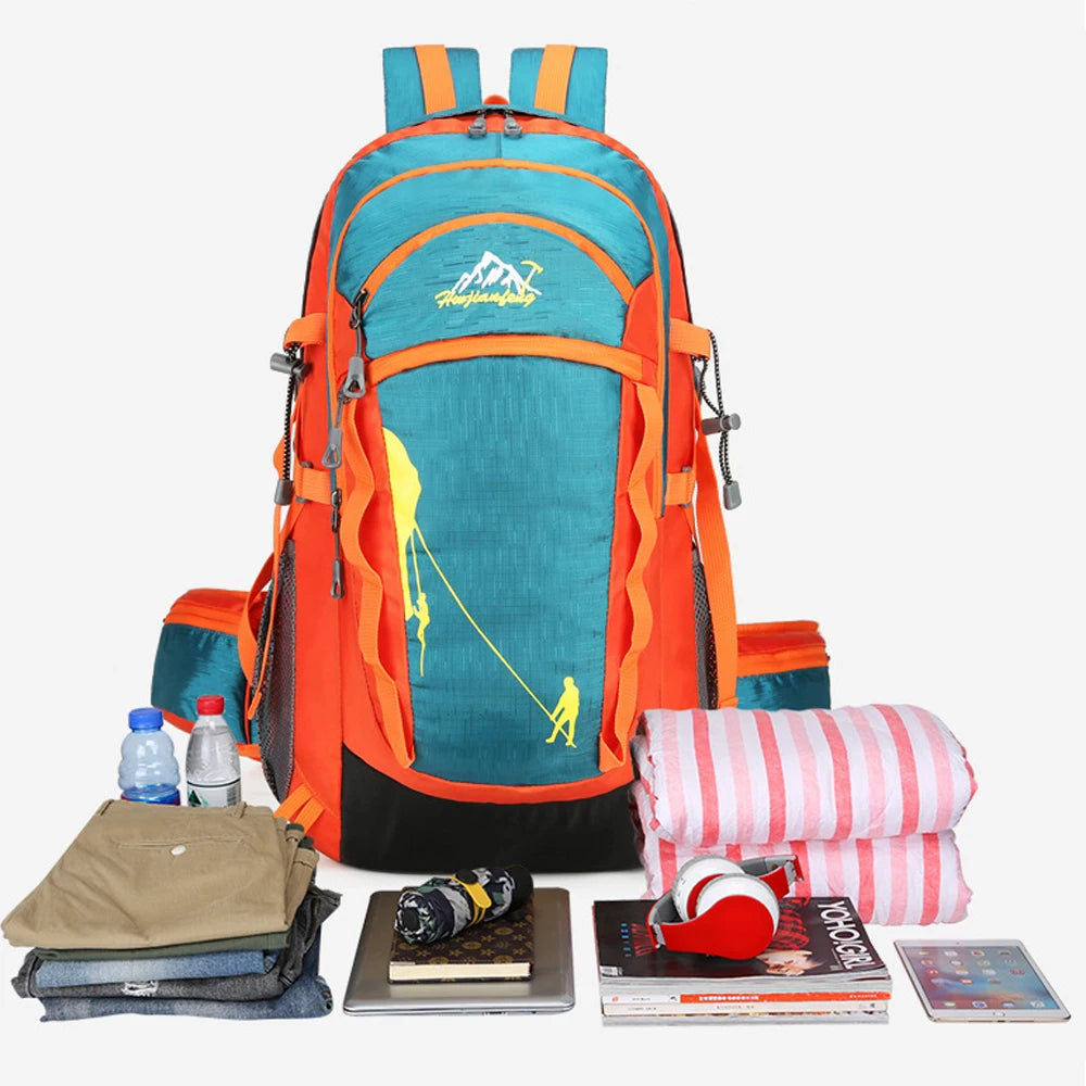 An orange and teal hiking backpack with yellow accents is shown next to various outdoor gear.