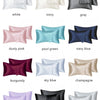 A collection of silky satin pillowcases in various colors including white, ivory, gray, dusty pink, teal, navy blue, burgundy