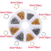 A white tray holds various sizes of gold and silver jump rings and clasps for jewelry making.