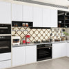 Modern kitchen cabinets featuring matte white and black finishes with a patterned backsplash.