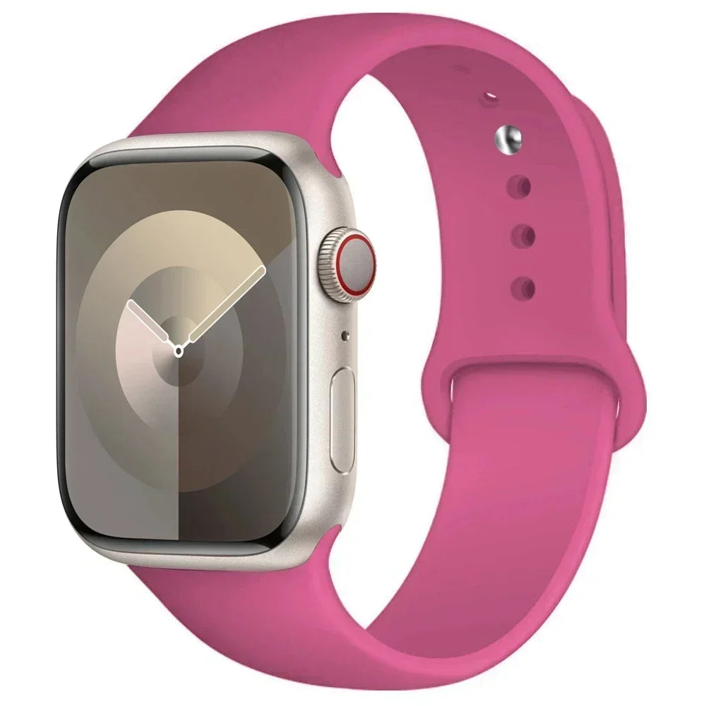 A pink silicone sport band is shown alongside an Apple Watch, highlighting the watch and strap.