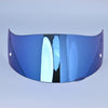 A close-up view of a motorcycle helmet visor lens shield with a blue tint and a reflective surface.
