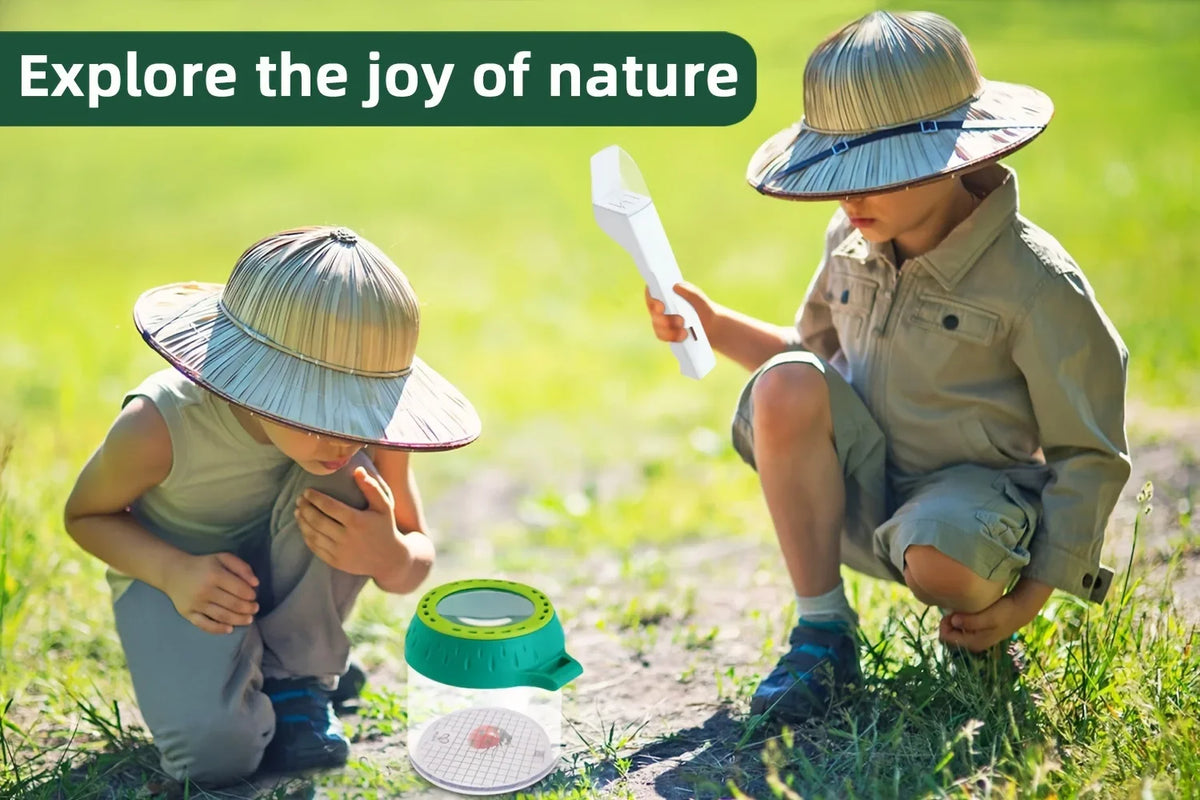 Two children explore nature, one holding a white handheld insect catcher clamp in a grassy outdoor setting.