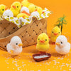 A woven basket filled with yellow chicks and a small white chick toy on an orange background.