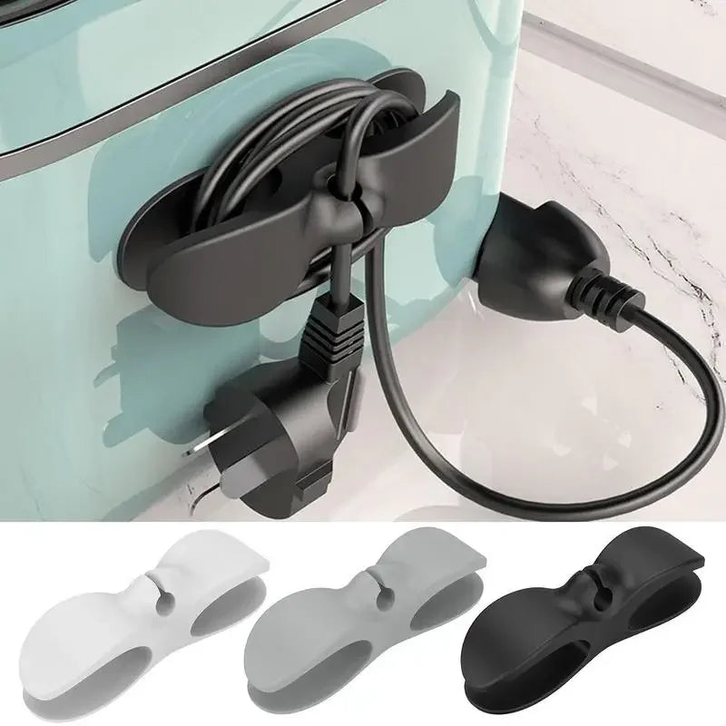 A set of black cord organizers and wire winders for tidy cable management, shown in various shades of gray and black.