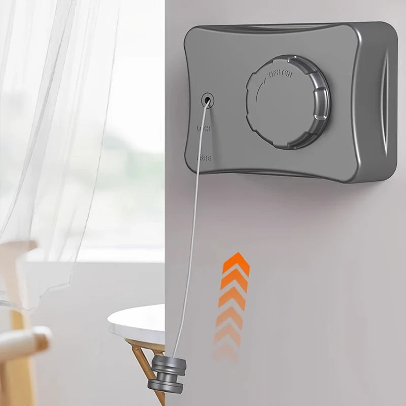 A gray retractable stainless steel clothesline mounted on a wall, with a cord extending downwards.
