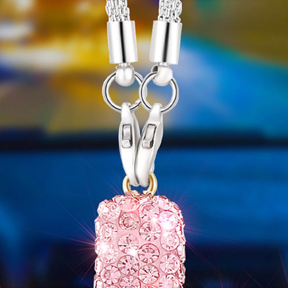 Silver stainless steel rhinestone cross pendant with a pink textured sphere charm