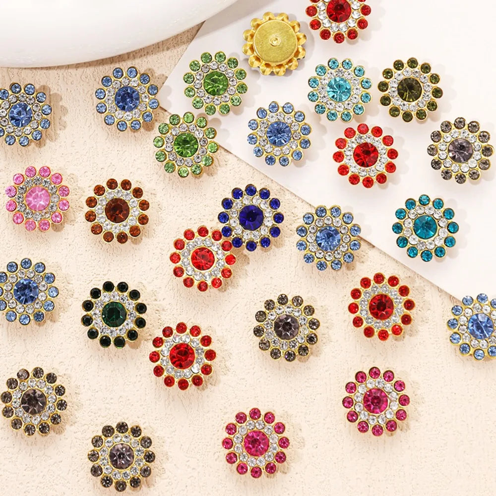 A collection of colorful multicolor sew-on flower rhinestones in various shades of green, blue, red, and gold.
