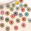 A collection of colorful multicolor sew-on flower rhinestones in various shades of green, blue, red, and gold.