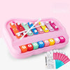 A pink Montessori musical xylophone piano set with colorful wooden bars and corresponding numbered tiles.