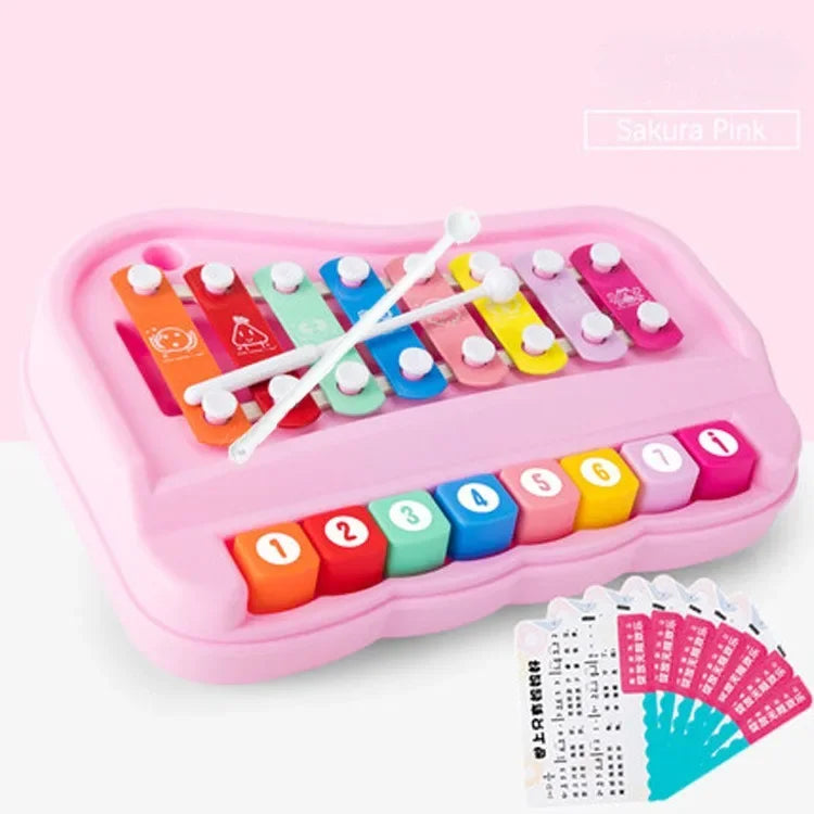A pink Montessori musical xylophone piano set with colorful wooden bars and corresponding numbered tiles.