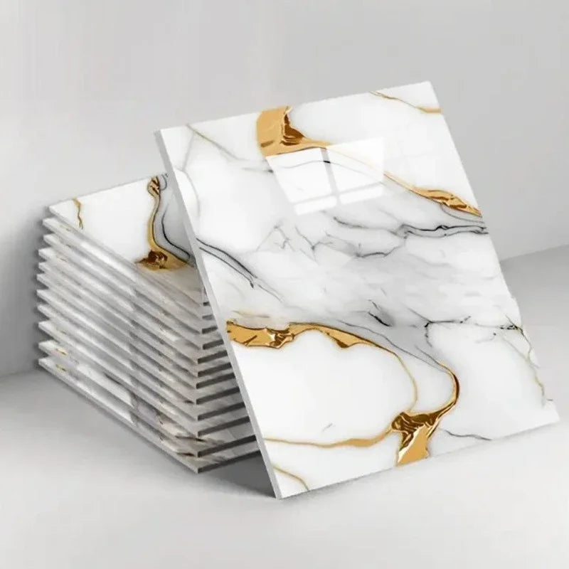 A stack of white marble peel-and-stick tiles with gold veining displayed on a white background.