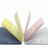 A collection of three laptop cases, including a yellow, a pink, and a silver one, displayed against a white background.