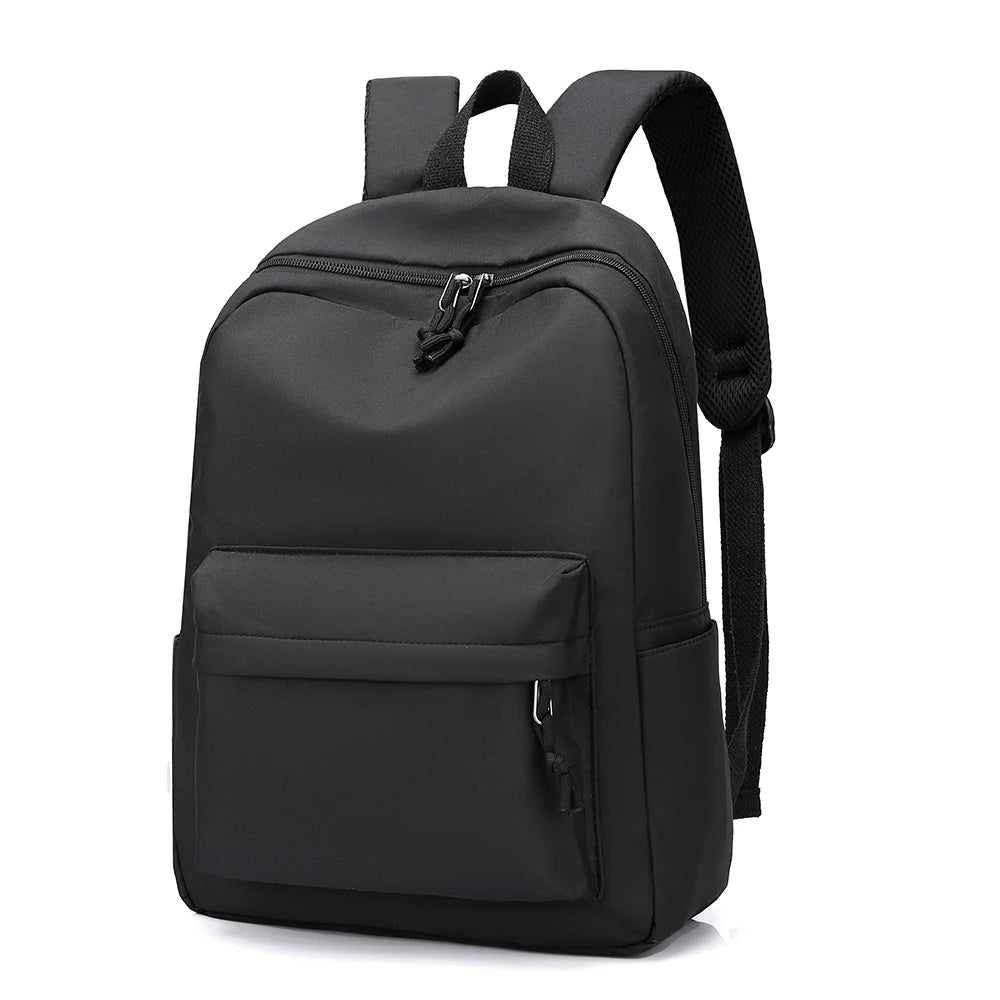 A black minimalist unisex canvas backpack with two zippered compartments and adjustable straps.