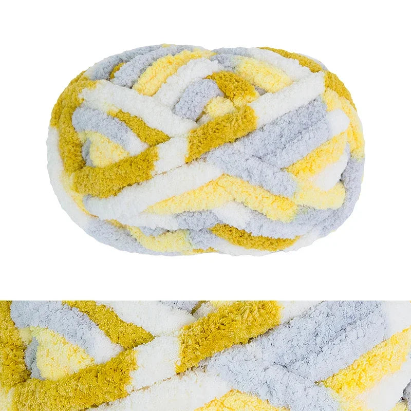 A ball of chunky chenille yarn featuring a marbled pattern of yellow and gray.