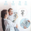 A woman holds a baby while demonstrating a sensory elephant plush toy with teether and comfort blanket for babies.