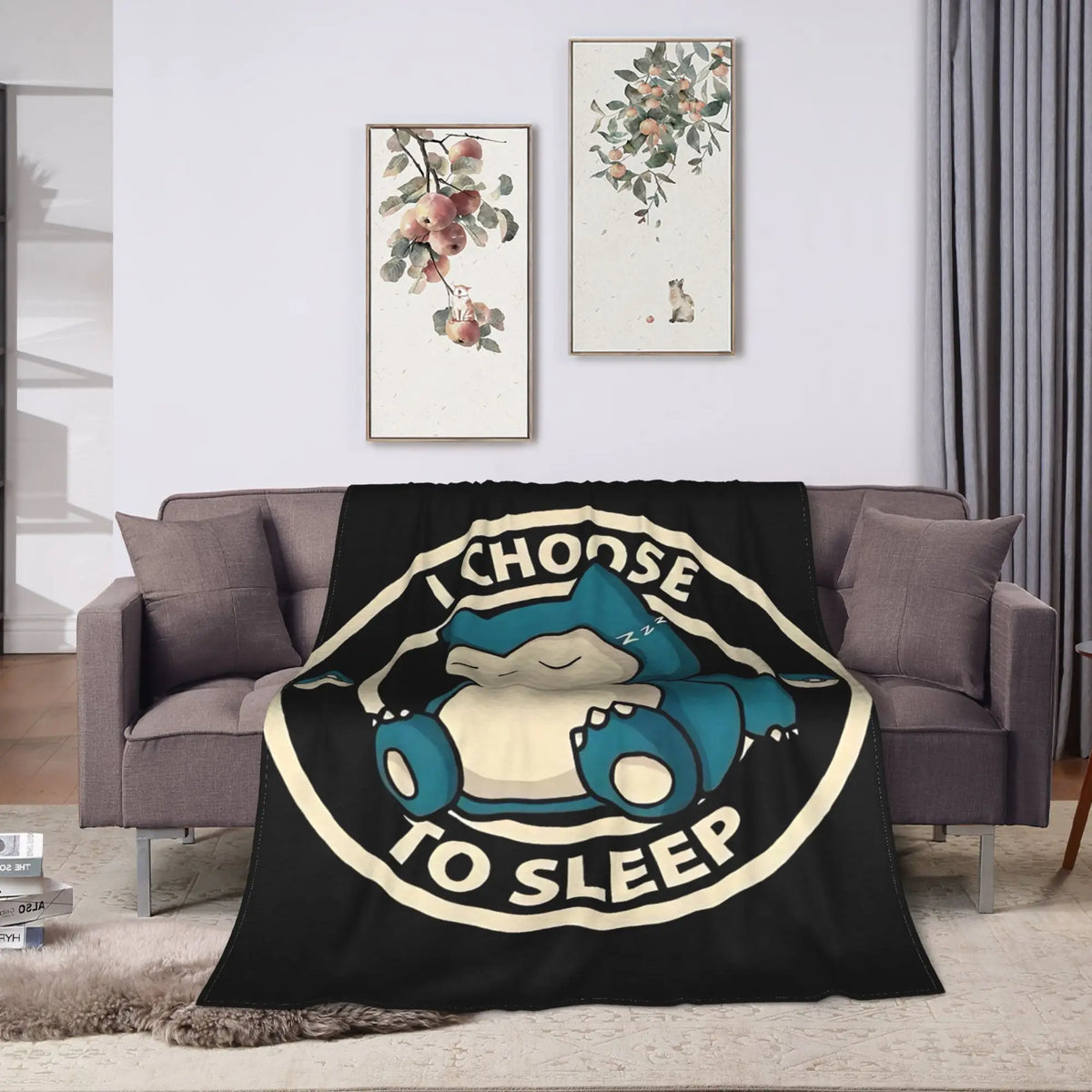 A black plush throw blanket featuring a graphic of a sleeping blue Snorlax character.