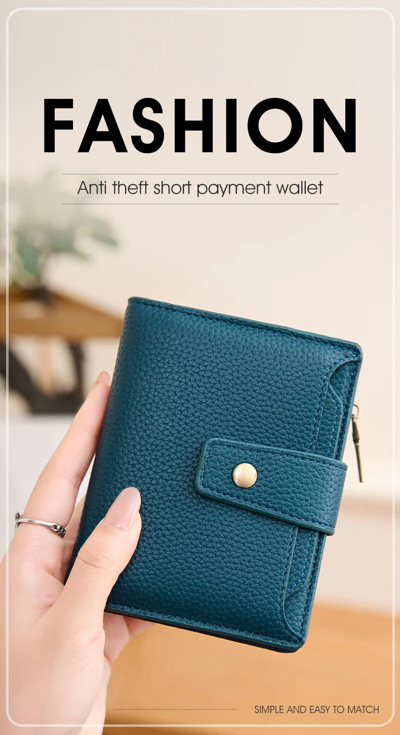 A teal anti theft short payment wallet is held in a hand, showing its texture and design.