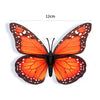 A pair of realistic orange and black monarch butterfly magnets with adhesive backing.