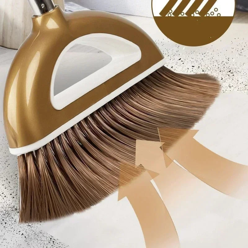 A golden floor wiper broom and dustpan set with a white handle and bristles shown on a light floor.
