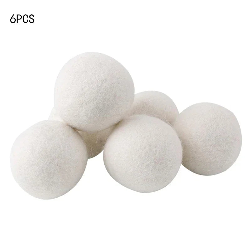 A set of six white natural wool dryer balls shown from above.