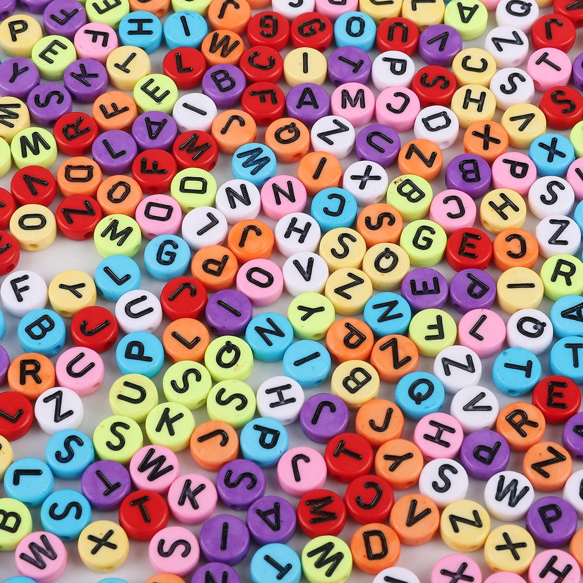 A colorful assortment of acrylic alphabet letter beads in various colors and shapes for jewelry making