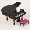 A black 1:12 scale dollhouse piano with a bench and sheet music displayed on a light-colored surface.