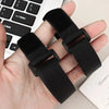 Black reusable nylon cable ties with adjustable hook and loop fasteners held in a hand next to a laptop keyboard