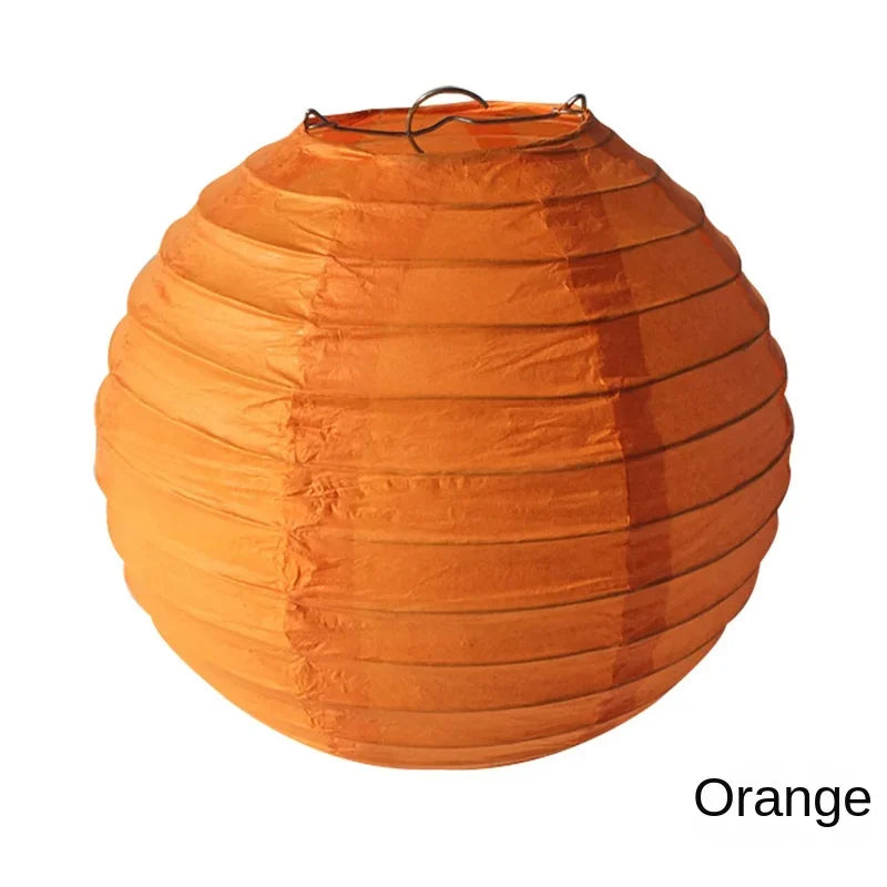 An orange paper lantern with a wire loop on top.
