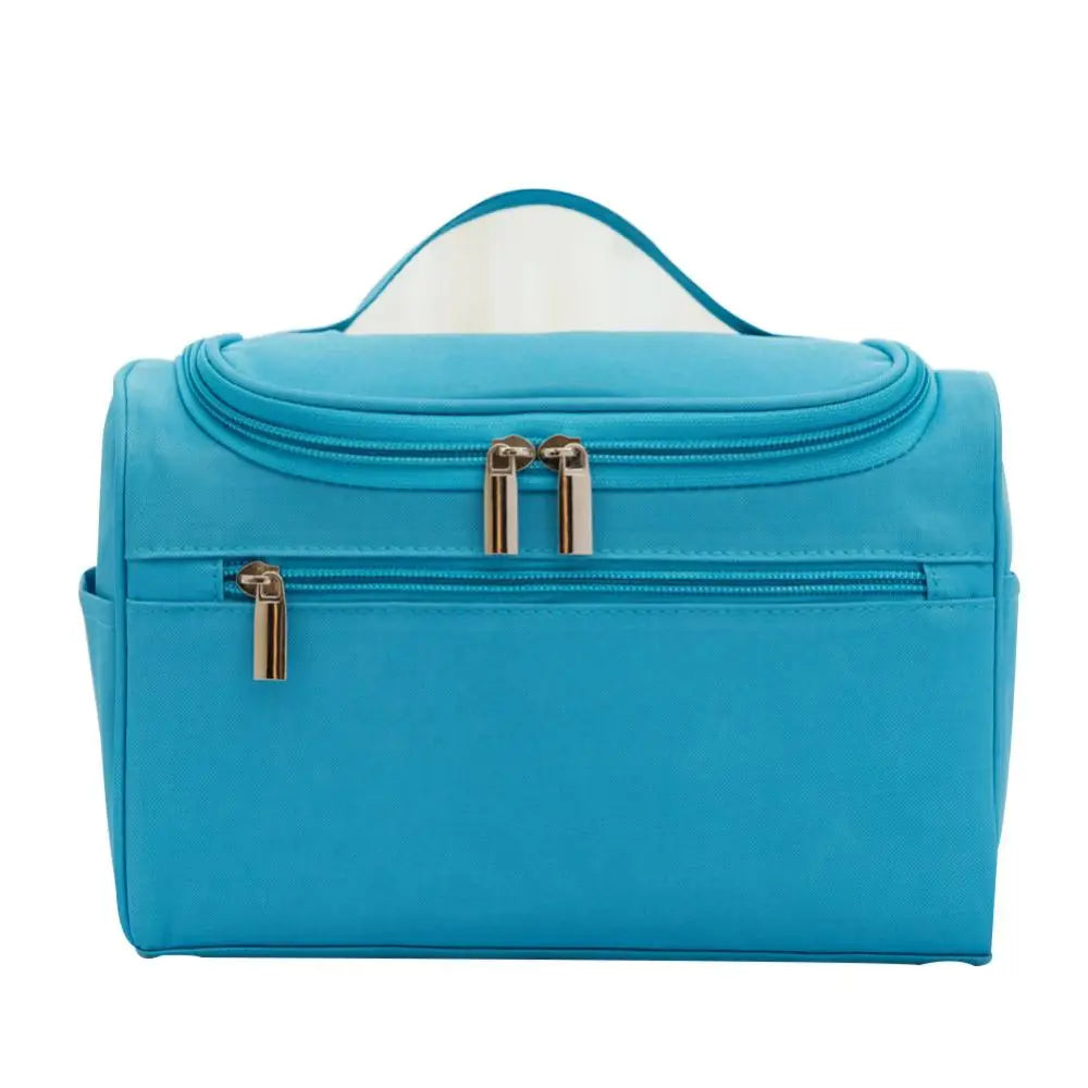 A teal waterproof hanging makeup bag with a clear lid and gold zippers.