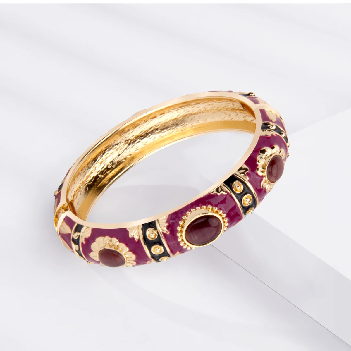 Rose gold plated bangle bracelet featuring deep purple enamel and reddish-brown stones