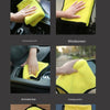 Yellow microfiber towel used for cleaning car interiors, including the windshield, mirror, and tablet surface.