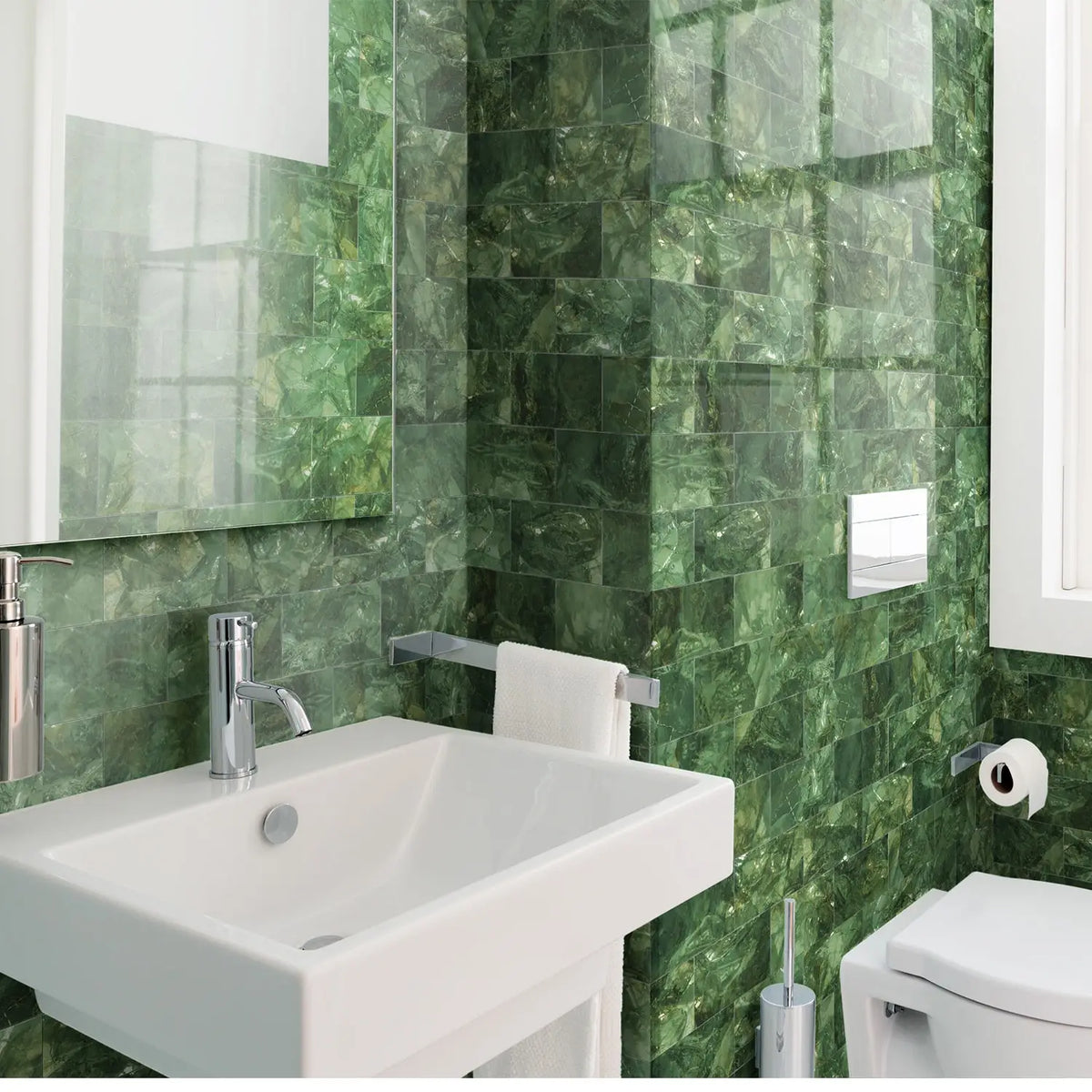A white bathroom sink and toilet are visible against a vibrant green marble self-adhesive tile backsplash.